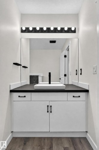 White vanity with dark countertop, vessel sink, and matte black faucet - 1315 Westerra Drive, Stony Plain, AB - Indoor