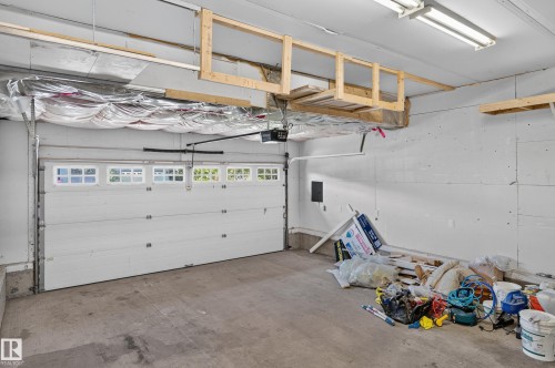 White garage door with upper window panels - 1315 Westerra Drive, Stony Plain, AB - Indoor Photo Showing Garage