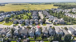 Aerial perspective of a residential neighborhood with a prominent green space - 