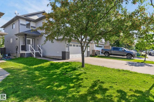 Contemporary exterior siding with contrasting trim, attached two-car garage, covered entry porch, and a paved driveway - 1315 Westerra Drive, Stony Plain, AB - Outdoor