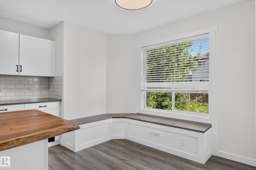 Built-in window bench with a dark countertop - 1315 Westerra Drive, Stony Plain, AB - Indoor Photo Showing Other Room