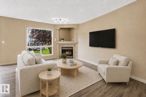 (virtually staged) - #60 1128 156 St Nw, Edmonton, AB - Indoor Photo Showing Living Room With Fireplace