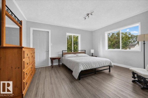 Wood-finish flooring, white window frames, and crown molding - 543069 Range Road 191, Rural Lamont County, AB - Indoor Photo Showing Bedroom
