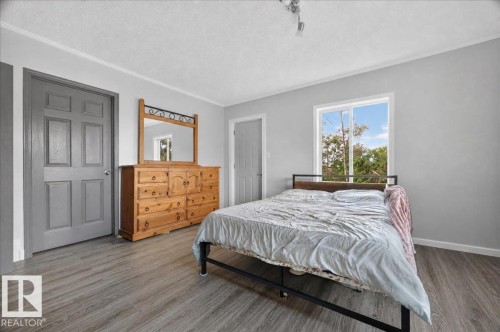 Neutral paint finishes throughout, modern wood-finish flooring, and a window with natural illumination - 543069 Range Road 191, Rural Lamont County, AB - Indoor Photo Showing Bedroom