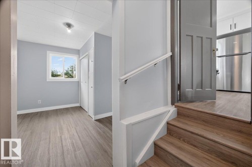Wood-finish flooring, light grey painted walls, white trim, a window with a white frame, and a closet with bi-fold doors - 543069 Range Road 191, Rural Lamont County, AB - Indoor Photo Showing Other Room