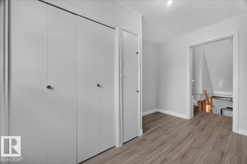 Wood-finish flooring with white trim, built-in bi-fold closet doors, and recessed lighting - 543069 Range Road 191, Rural Lamont County, AB - Indoor Photo Showing Other Room