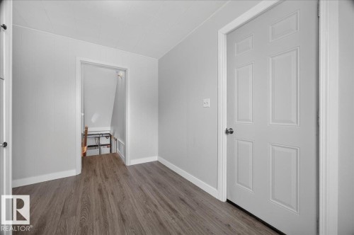 Wood-finish flooring with light gray walls, white trim, and white paneled doors - 543069 Range Road 191, Rural Lamont County, AB - Indoor Photo Showing Other Room
