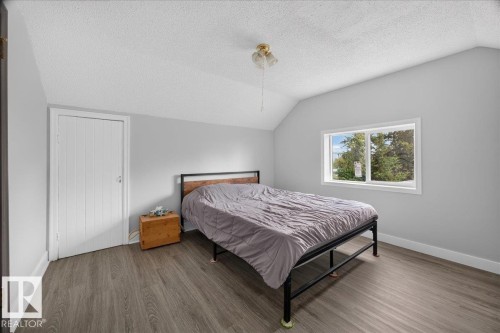 Wood-finish flooring, white paneled door, and a white-framed window - 543069 Range Road 191, Rural Lamont County, AB - Indoor Photo Showing Bedroom