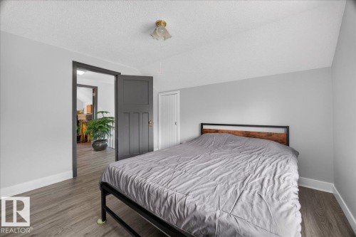 Wood-finish flooring, light gray wall paint, and a classic-style ceiling light fixture - 543069 Range Road 191, Rural Lamont County, AB - Indoor Photo Showing Bedroom