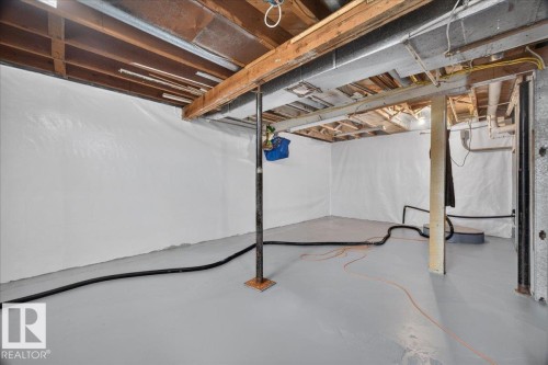 Basement space featuring exposed ceiling joists, white wall covering, and a gray painted concrete floor - 543069 Range Road 191, Rural Lamont County, AB - Indoor Photo Showing Basement