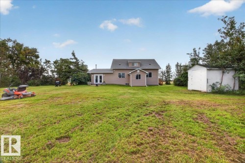 Expansive green space featuring a two-story residence with a dormer and a detached storage shed - 543069 Range Road 191, Rural Lamont County, AB - Outdoor