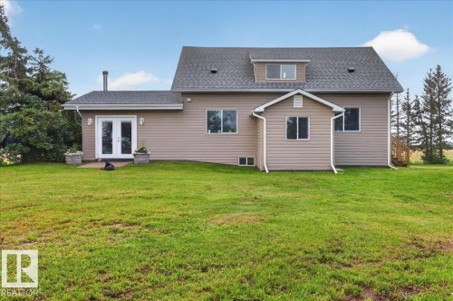 Exterior featuring light brown siding, a dark shingle roof, a dormer window, and white-framed windows - 543069 Range Road 191, Rural Lamont County, AB - Outdoor