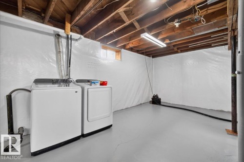 Unfinished basement with exposed ceiling beams, white wall finishes, and a concrete floor - 543069 Range Road 191, Rural Lamont County, AB - Indoor Photo Showing Laundry Room
