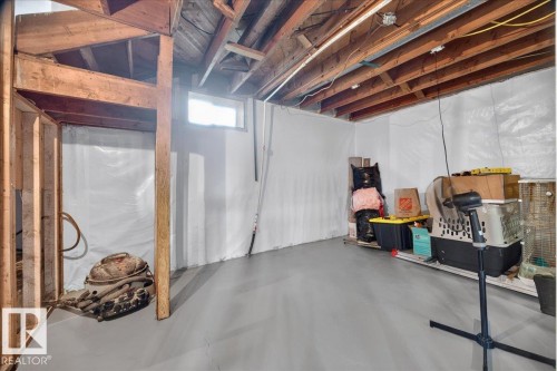 Unfinished basement with exposed wood joists and a single window - 543069 Range Road 191, Rural Lamont County, AB - Indoor Photo Showing Basement