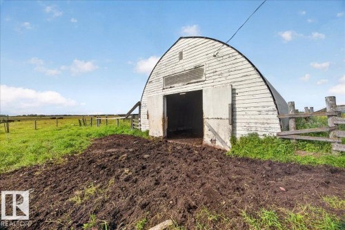 Arched white barn structure with double entry doors and a slatted vent - 543069 Range Road 191, Rural Lamont County, AB - Outdoor