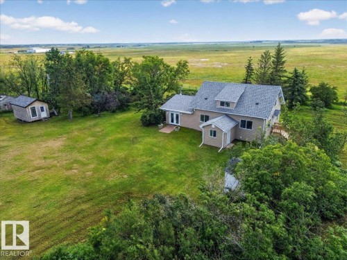 Exterior residence with dormer windows, light-colored siding, and a gabled roof - 543069 Range Road 191, Rural Lamont County, AB - Outdoor With View