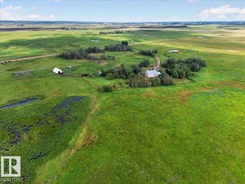 Expansive green acreage featuring a primary residence, a large outbuilding, and multiple smaller structures - 543069 Range Road 191, Rural Lamont County, AB - Outdoor With View