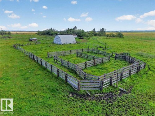 Expansive green acreage featuring a large wooden fence system, quonset hut, and additional outbuilding - 543069 Range Road 191, Rural Lamont County, AB - Outdoor With View