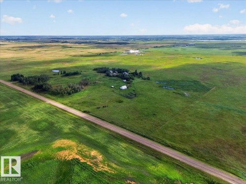 Expansive green landscape featuring a dirt road, multiple small structures, and scattered trees - 543069 Range Road 191, Rural Lamont County, AB - Outdoor With View