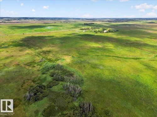 Expansive green landscape featuring varied terrain and distant structures - 543069 Range Road 191, Rural Lamont County, AB - Outdoor With View