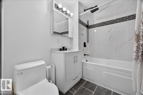 White vanity with a light-toned countertop, modern matte black fixtures, and a sleek rectangular medicine cabinet - 543069 Range Road 191, Rural Lamont County, AB - Indoor Photo Showing Bathroom