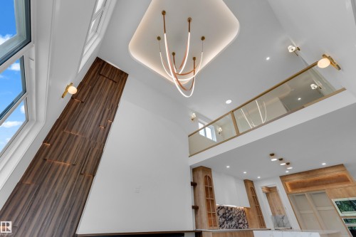 Soaring ceilings with a unique curved light fixture - 2408 1 Avenue Sw, Edmonton, AB - Indoor Photo Showing Other Room