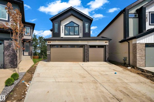 Contemporary exterior with dark siding and white trim accents - 2408 1 Avenue Sw, Edmonton, AB - Outdoor With Facade