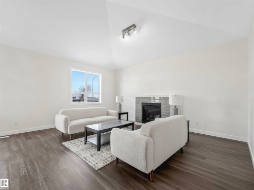#1 7800 94 St, Morinville, AB - Indoor Photo Showing Living Room With Fireplace