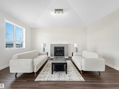 #1 7800 94 St, Morinville, AB - Indoor Photo Showing Living Room With Fireplace