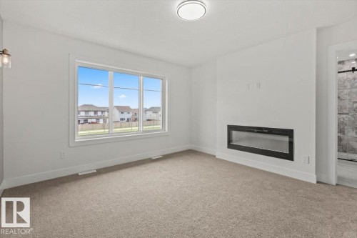69 Elliott Wynd, Fort Saskatchewan, AB - Indoor Photo Showing Other Room With Fireplace