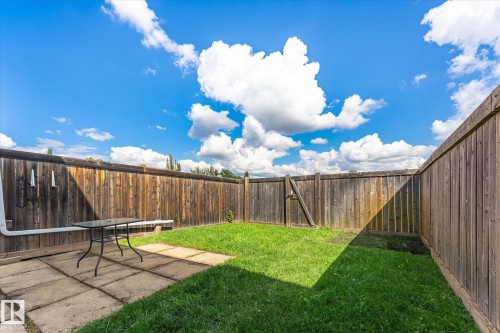Fenced backyard featuring a paved patio area and green lawn - 18307 66 Avenue Nw, Edmonton, AB - Outdoor