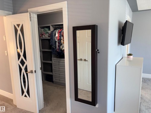 Custom closet with built-in shelving, drawers, and hanging rods - 1452 36A Avenue Nw, Edmonton, AB - Indoor Photo Showing Other Room