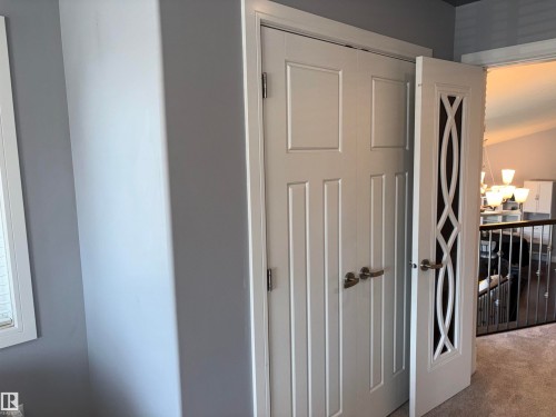 White paneled doors with brushed nickel hardware - 1452 36A Avenue Nw, Edmonton, AB - Indoor Photo Showing Other Room