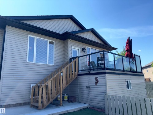 Exterior siding with white trim windows and black eaves - 1452 36A Avenue Nw, Edmonton, AB - Outdoor With Exterior