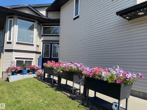 Siding exterior with contrasting trim, multiple windows including a bay window, and a double-door entry - 1452 36A Avenue Nw, Edmonton, AB - Outdoor With Exterior