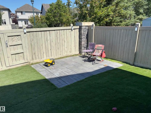 Paved patio area, stone column, privacy fencing, and artificial turf - 1452 36A Avenue Nw, Edmonton, AB - Outdoor