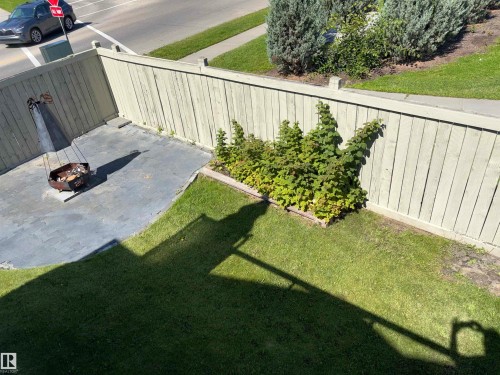 Fenced backyard featuring a paved patio area and a separate lawn section - 1452 36A Avenue Nw, Edmonton, AB - Outdoor