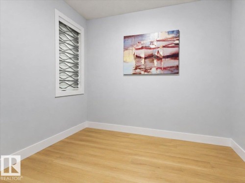 Wood-finish flooring with white baseboards, a window with horizontal slat blinds, and light-toned wall paint - 6903 169 Avenue Nw, Edmonton, AB - Indoor Photo Showing Other Room