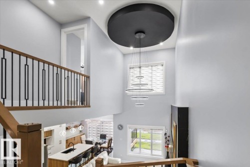 Two-story ceiling with recessed lighting and a contemporary chandelier - 6903 169 Avenue Nw, Edmonton, AB - Indoor Photo Showing Other Room