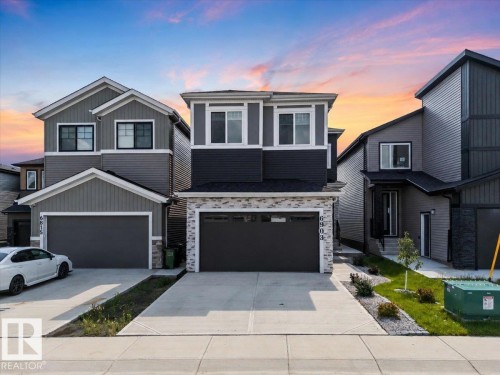 Multi-tone siding exterior with a stone veneer accent - 6903 169 Avenue Nw, Edmonton, AB - Outdoor With Facade