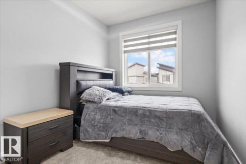 Window with blinds, wall-to-wall carpeting, light-toned walls, and recessed lighting - 6903 169 Avenue Nw, Edmonton, AB - Indoor Photo Showing Bedroom