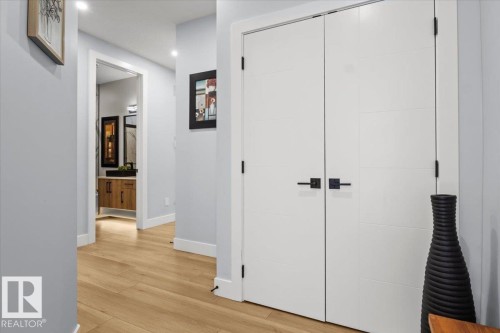 Wide plank wood-finish flooring, recessed lighting, white trim, and a modern vanity with wood cabinetry - 6903 169 Avenue Nw, Edmonton, AB - Indoor Photo Showing Other Room
