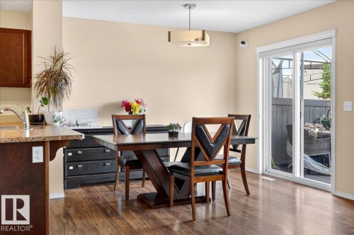 Wood-finish flooring throughout, complemented by a contemporary ceiling light fixture - 1529 26 Ave Nw Nw, Edmonton, AB - Indoor