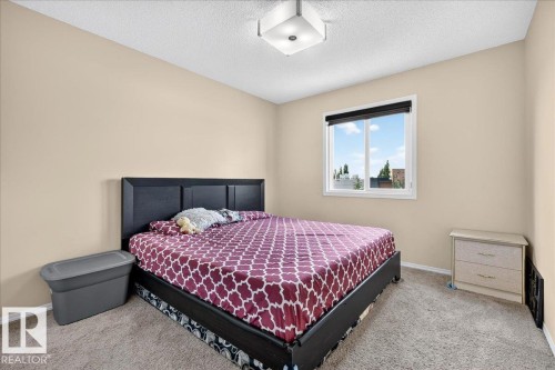 Neutral-toned walls complement the textured carpeting - 1529 26 Ave Nw Nw, Edmonton, AB - Indoor Photo Showing Bedroom