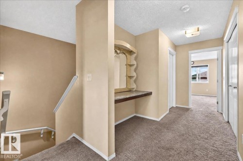 Hallway featuring carpet flooring, a built-in vanity with a countertop, and recessed lighting - 1529 26 Ave Nw Nw, Edmonton, AB - Indoor Photo Showing Other Room
