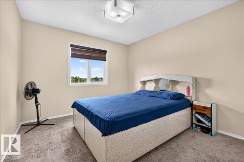 Neutral-toned walls complement the carpeted flooring - 1529 26 Ave Nw Nw, Edmonton, AB - Indoor Photo Showing Bedroom