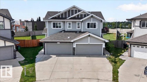 Two-story residence featuring light gray siding with dark gray trim accents and a dual attached garage - 1529 26 Ave Nw Nw, Edmonton, AB - Outdoor