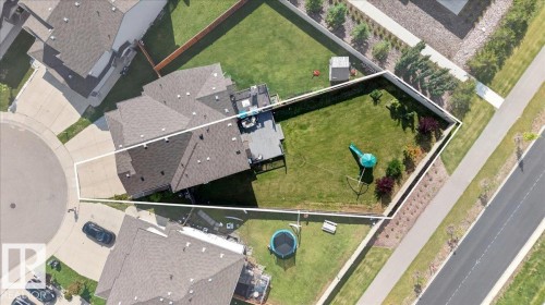 Aerial view of a residential property with a multi-level home, an expansive green lawn, and a paved street - 1529 26 Ave Nw Nw, Edmonton, AB - Outdoor With View