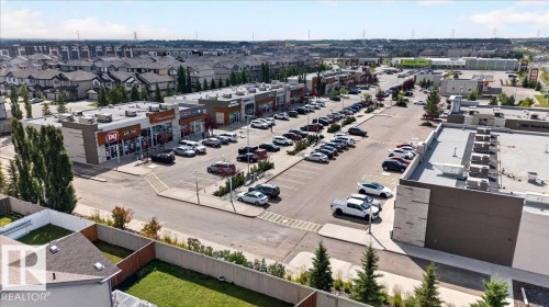 Commercial retail development with multiple storefronts and expansive surface parking - 1529 26 Ave Nw Nw, Edmonton, AB - Outdoor With View