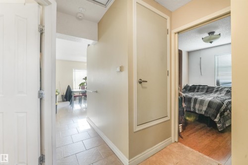 Hallway with light-colored walls and tiled flooring - 12209 94 Street Nw, Edmonton, AB - Indoor Photo Showing Other Room